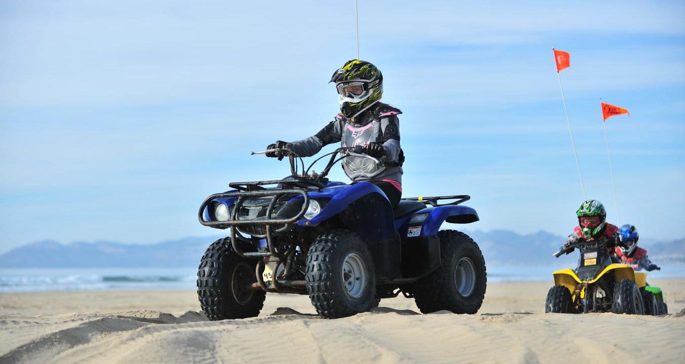 Riders on ATVs on a desert trail